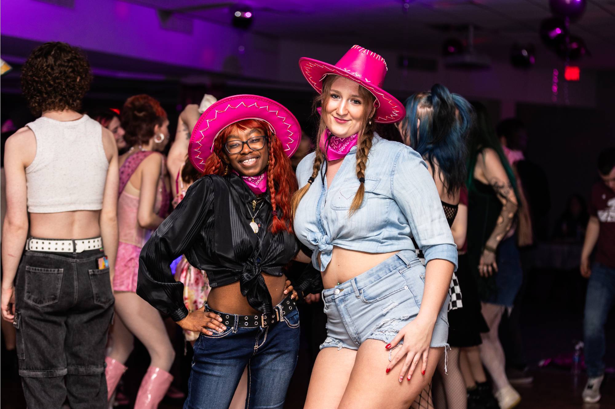 two students pose smiling